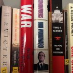 Close-up of book bindings on a shelf containing journalistic non-fiction books.