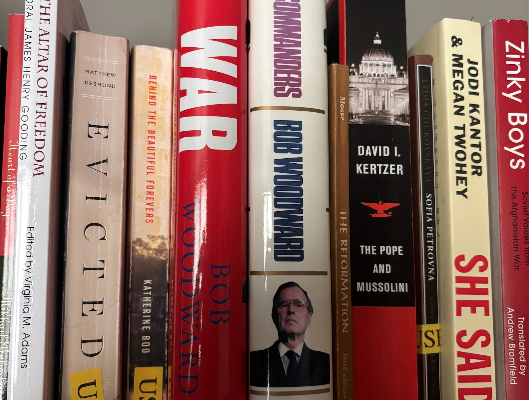 Close-up of book bindings on a shelf containing journalistic non-fiction books.