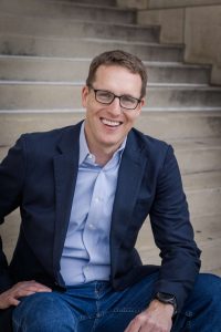 Photo of David Fahrenthold sitting on steps, from the waist up
