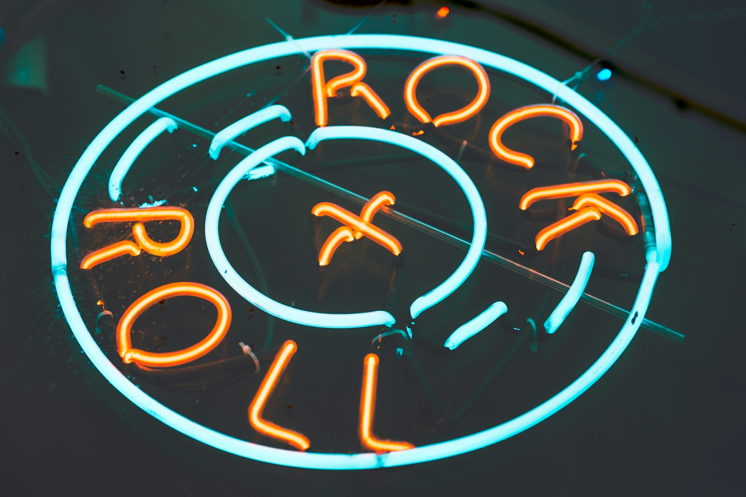 A neon sign reading "Rock + Roll."