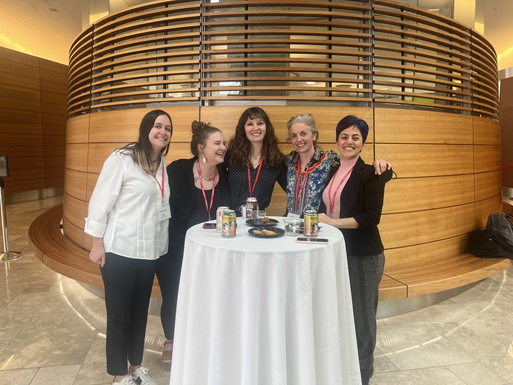Fellows Emily Knepple, Erin McGroarty, Lydia Slattery and Tahereh Rahimi celebrate the end of the 2022 conference with Center administrator Krista Eastman.